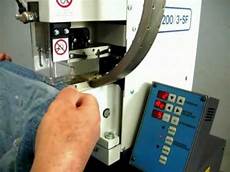 Snap fastening machine